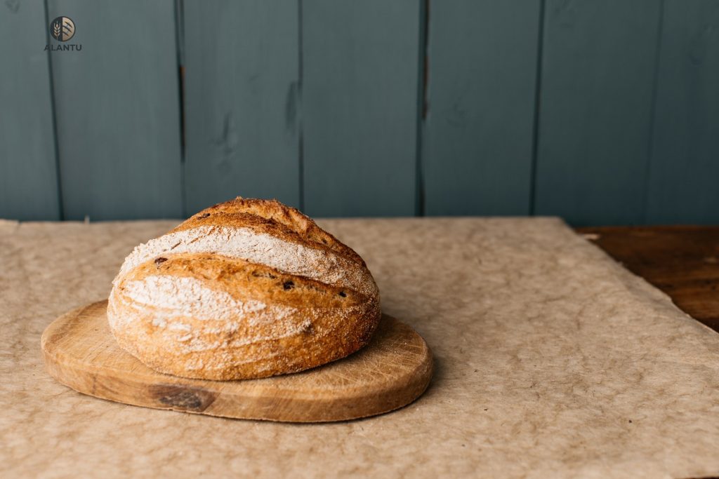 alantu kalamata olive sourdough loaf on board.jpg
